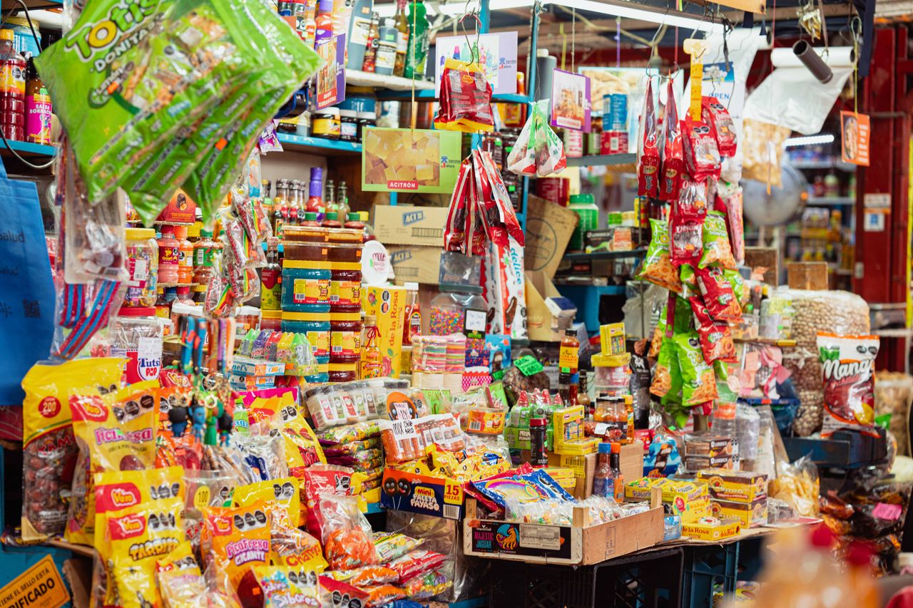 Colorful market stall in Ciudad de México filled with assorted Mexican candies and snacks.