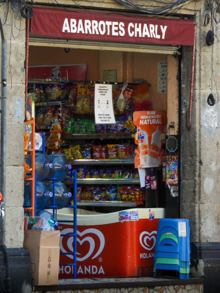 Vibrant local convenience store 'Abarrotes Charly' in Mexico City, displaying snacks and drinks.